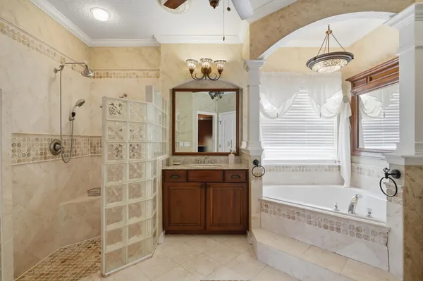 a bathroom with a tub sink and mirror