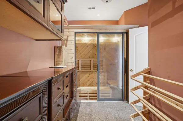 a bathroom with a granite countertop sink and a shower