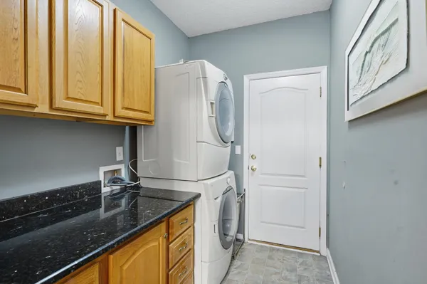 a kitchen with stainless steel appliances granite countertop a sink and a refrigerator