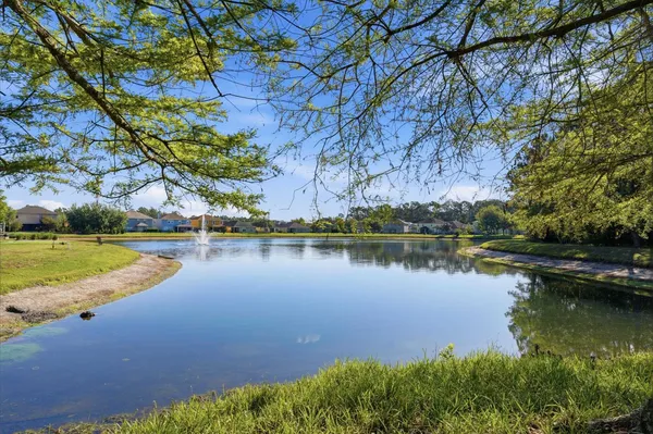 a view of a lake with houses in the back