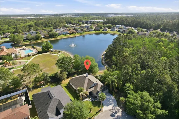 an aerial view of lake residential house with outdoor space and swimming pool