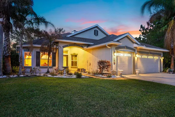 a front view of a house with a big yard