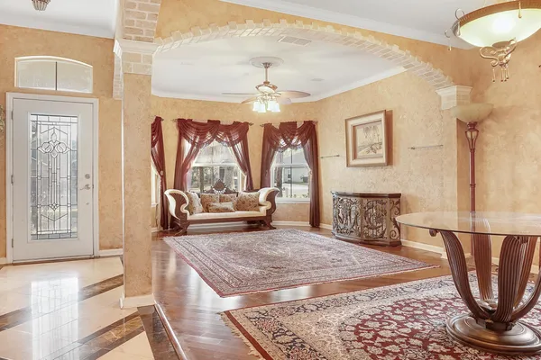 a living room with furniture a rug and a chandelier
