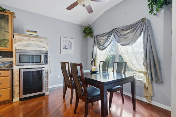 a view of a dining room with furniture window and wooden floor