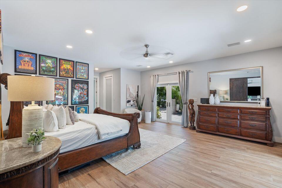 2311 Northeast 47th Street Lighthouse Point, FL 33064 - Photo 25 of 40 a bedroom with a large bed and a couch