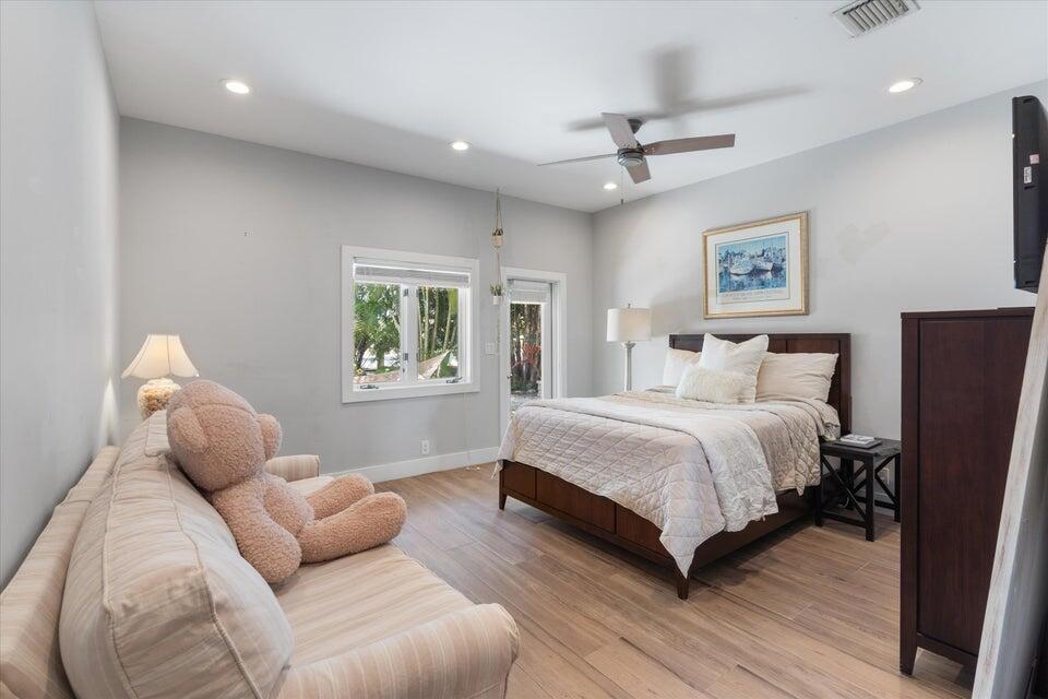 2311 Northeast 47th Street Lighthouse Point, FL 33064 - Photo 31 of 40 a bedroom with a large bed and a window