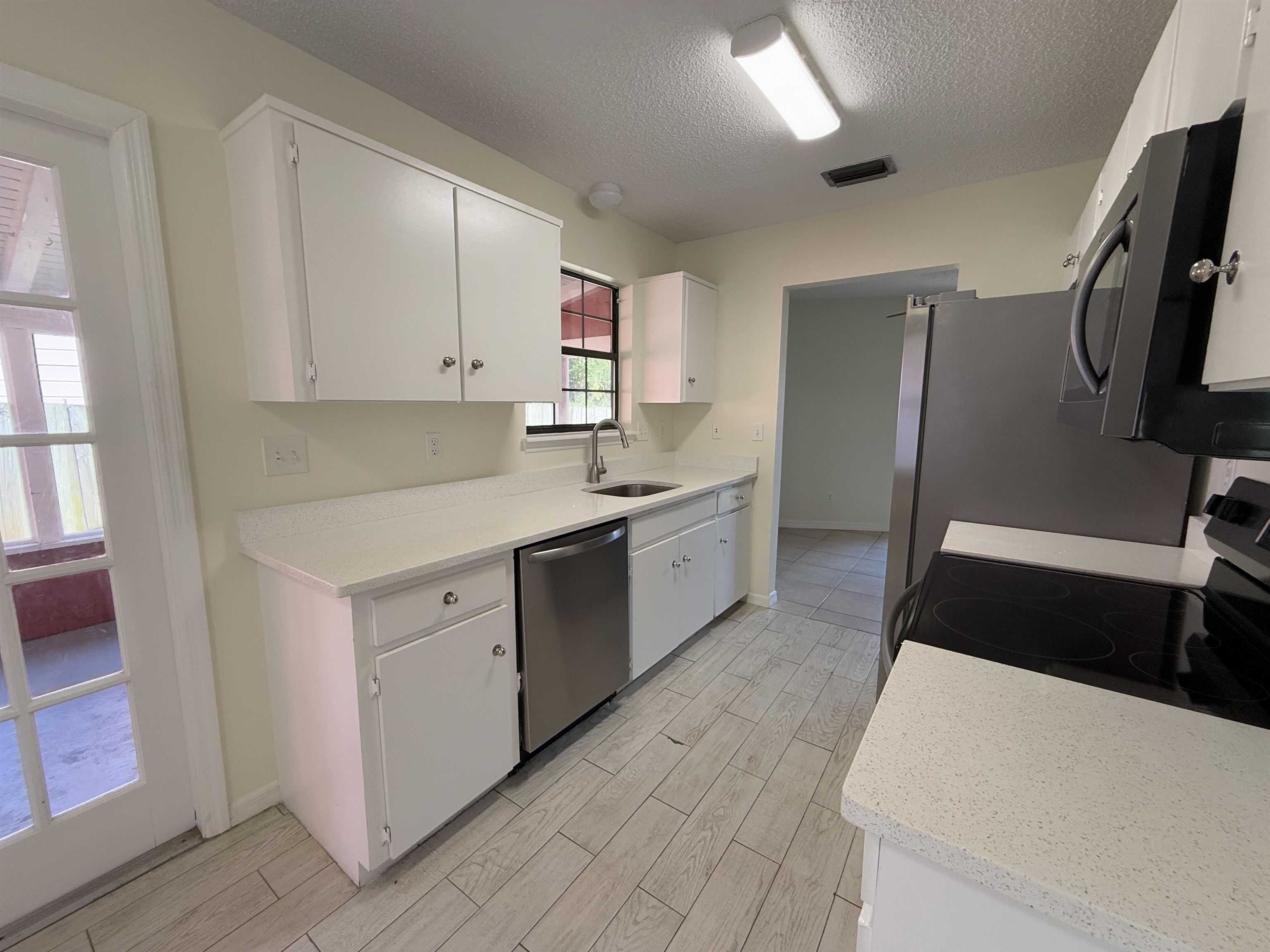 3 Agnes Circle St. Augustine, FL 32080 - Photo 3 of 15 a kitchen with a sink a stove top oven and wooden floor