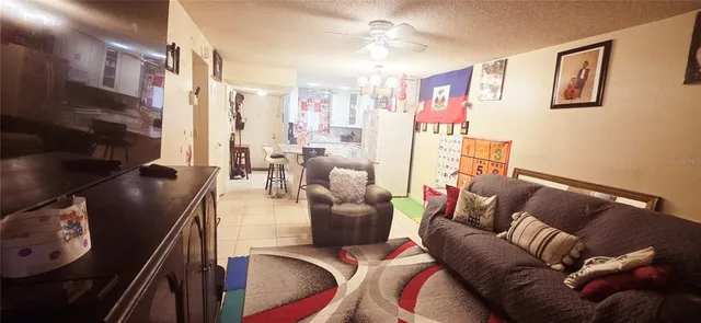 a living room with furniture and a chandelier