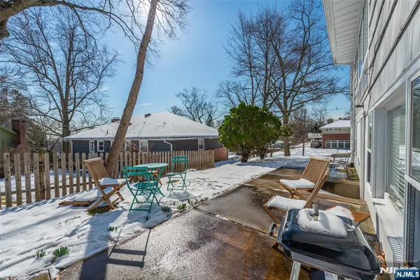 a view of a patio with chairs and tables on the deck