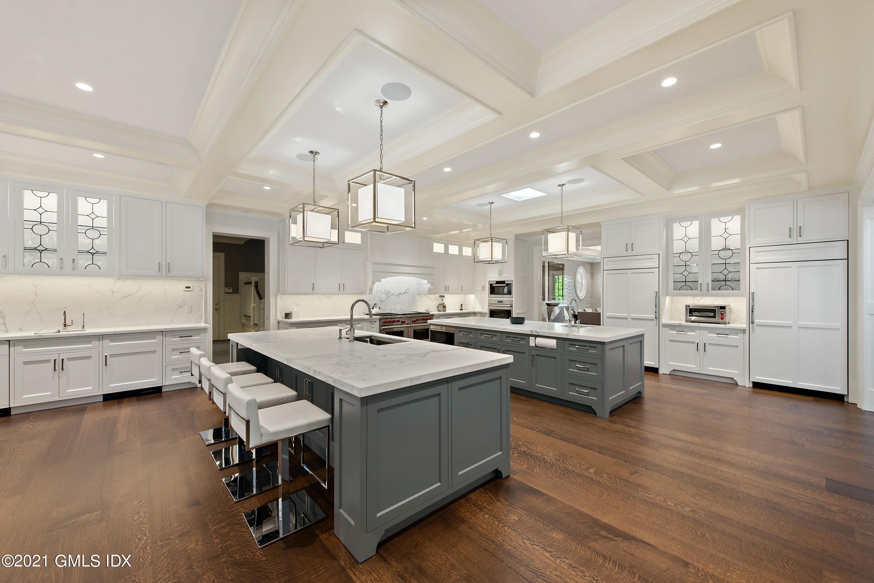 434 Riversville Road Greenwich, CT 06831 - Photo 14 of 47 a kitchen with stainless steel appliances a stove a sink a kitchen island with wooden floor and cabinets