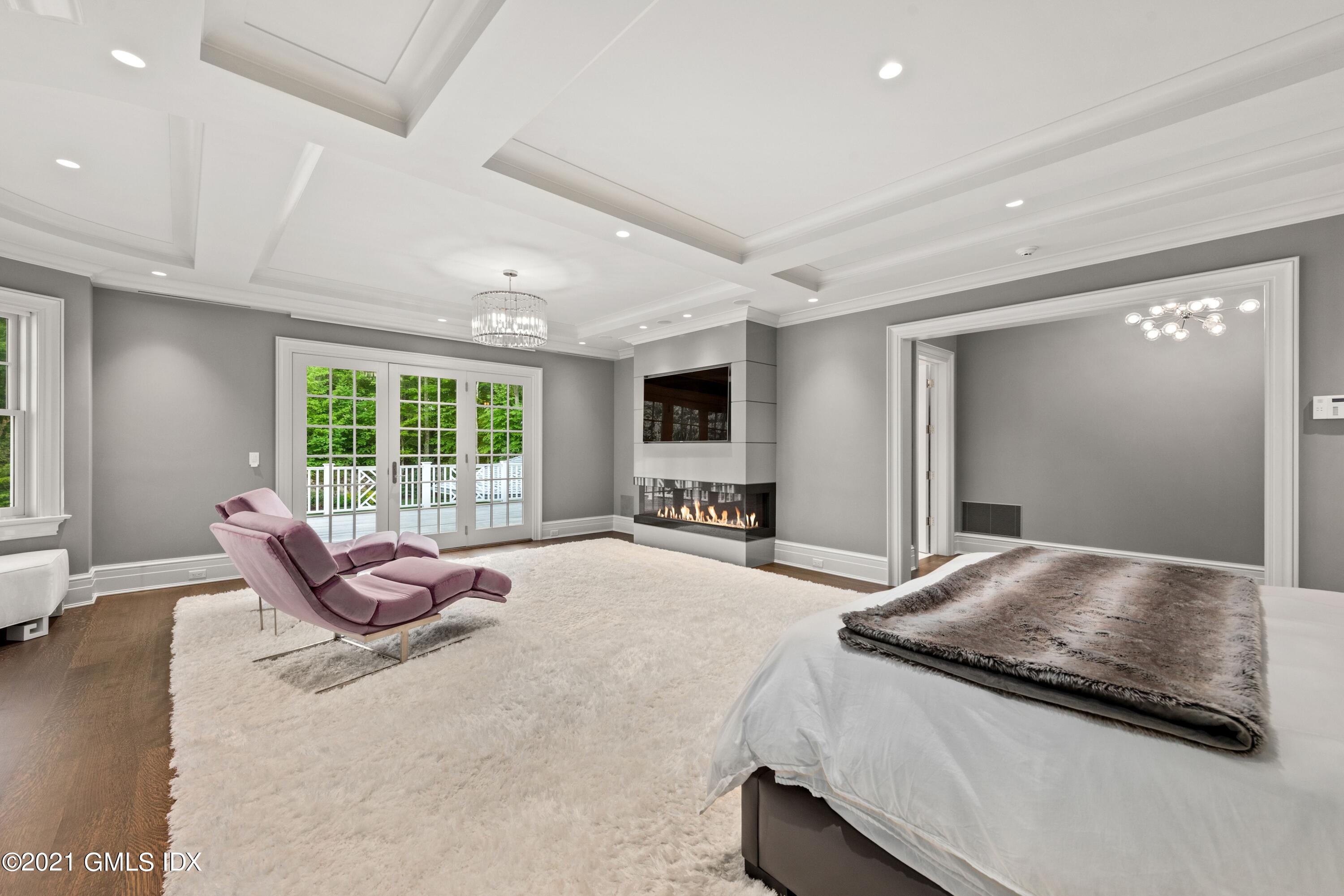 434 Riversville Road Greenwich, CT 06831 - Photo 18 of 47 a spacious bedroom with a bed and glass window