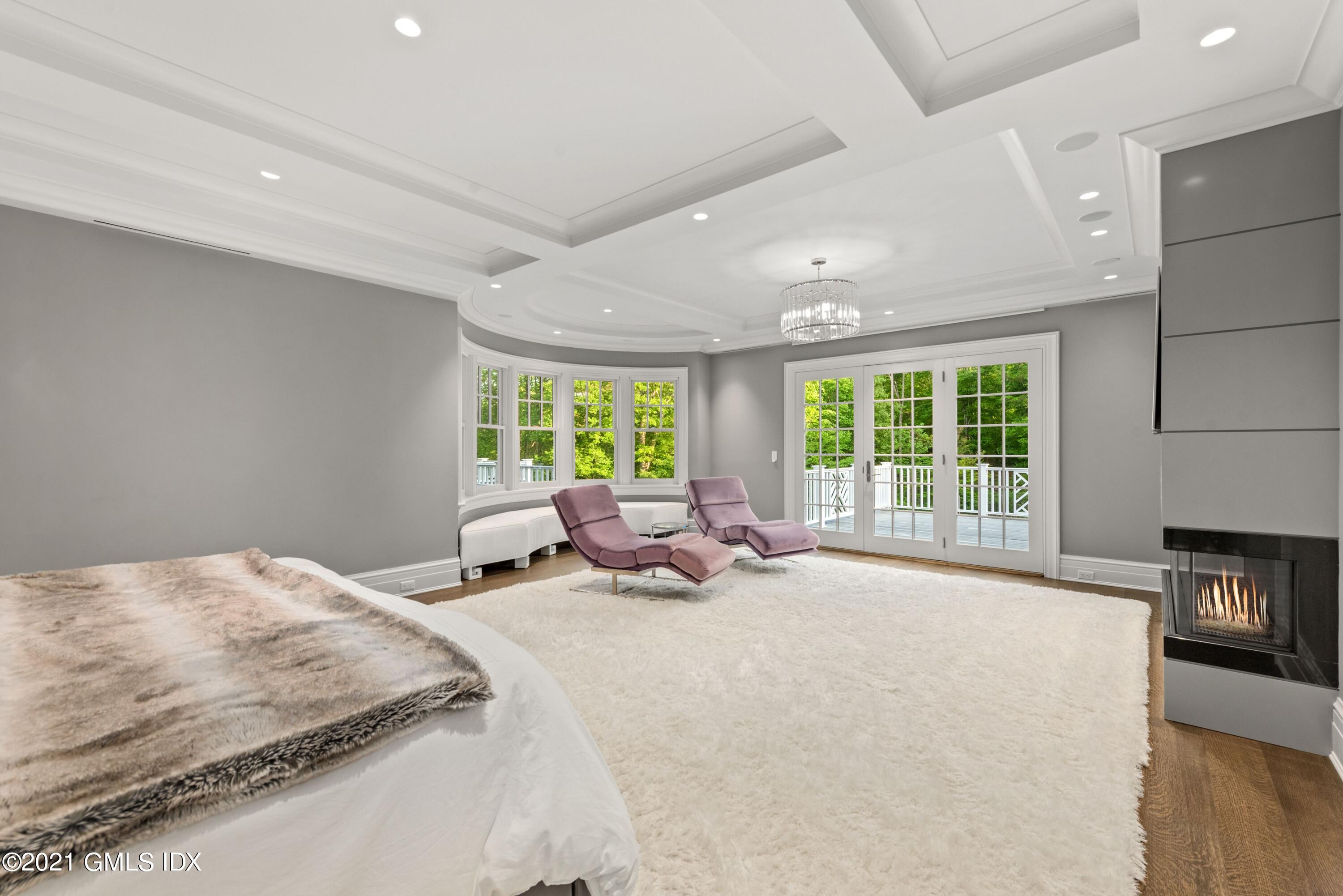 434 Riversville Road Greenwich, CT 06831 - Photo 19 of 47 a bedroom with a bed and large windows