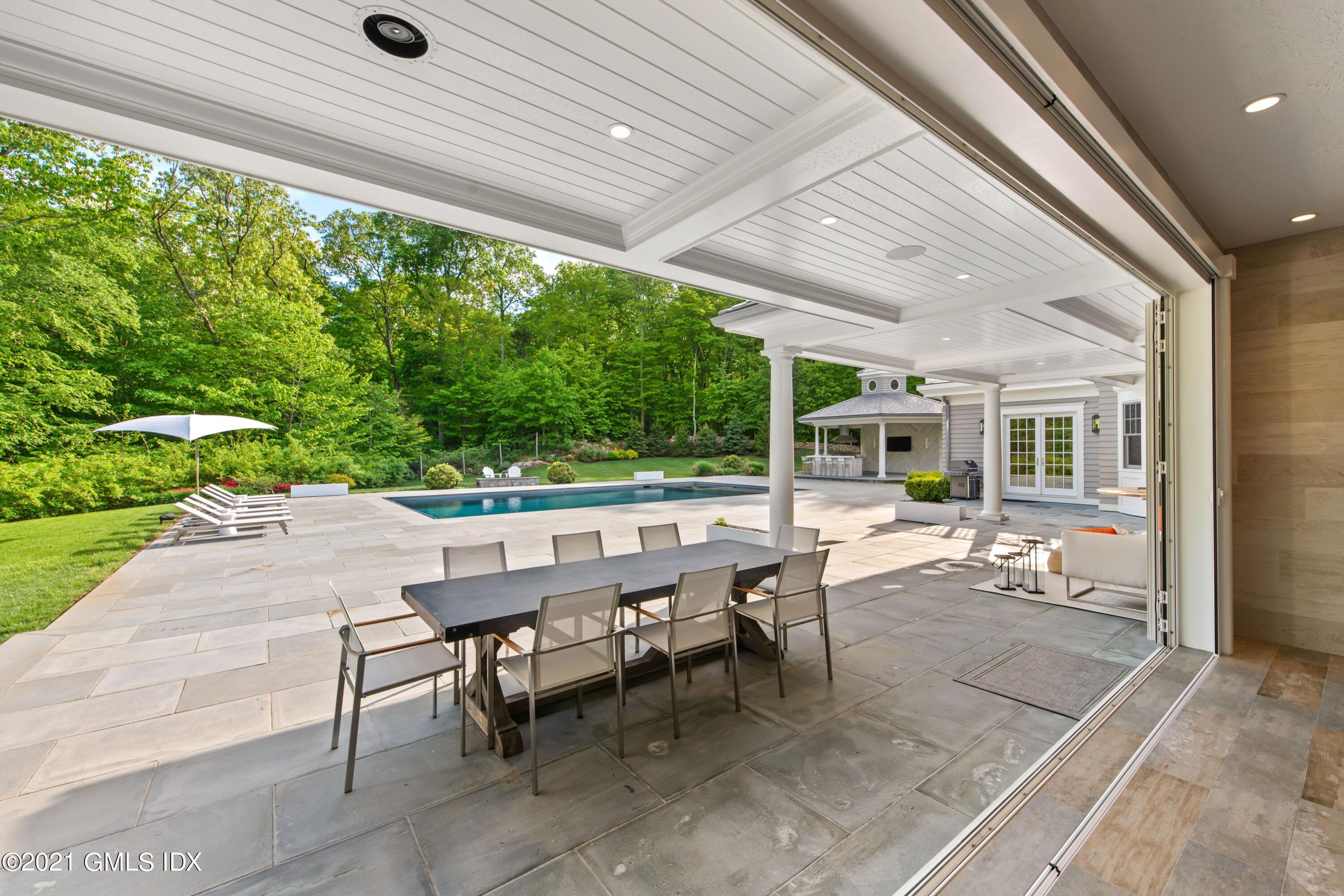 434 Riversville Road Greenwich, CT 06831 - Photo 35 of 47 a view of a patio with table and chairs and potted plants