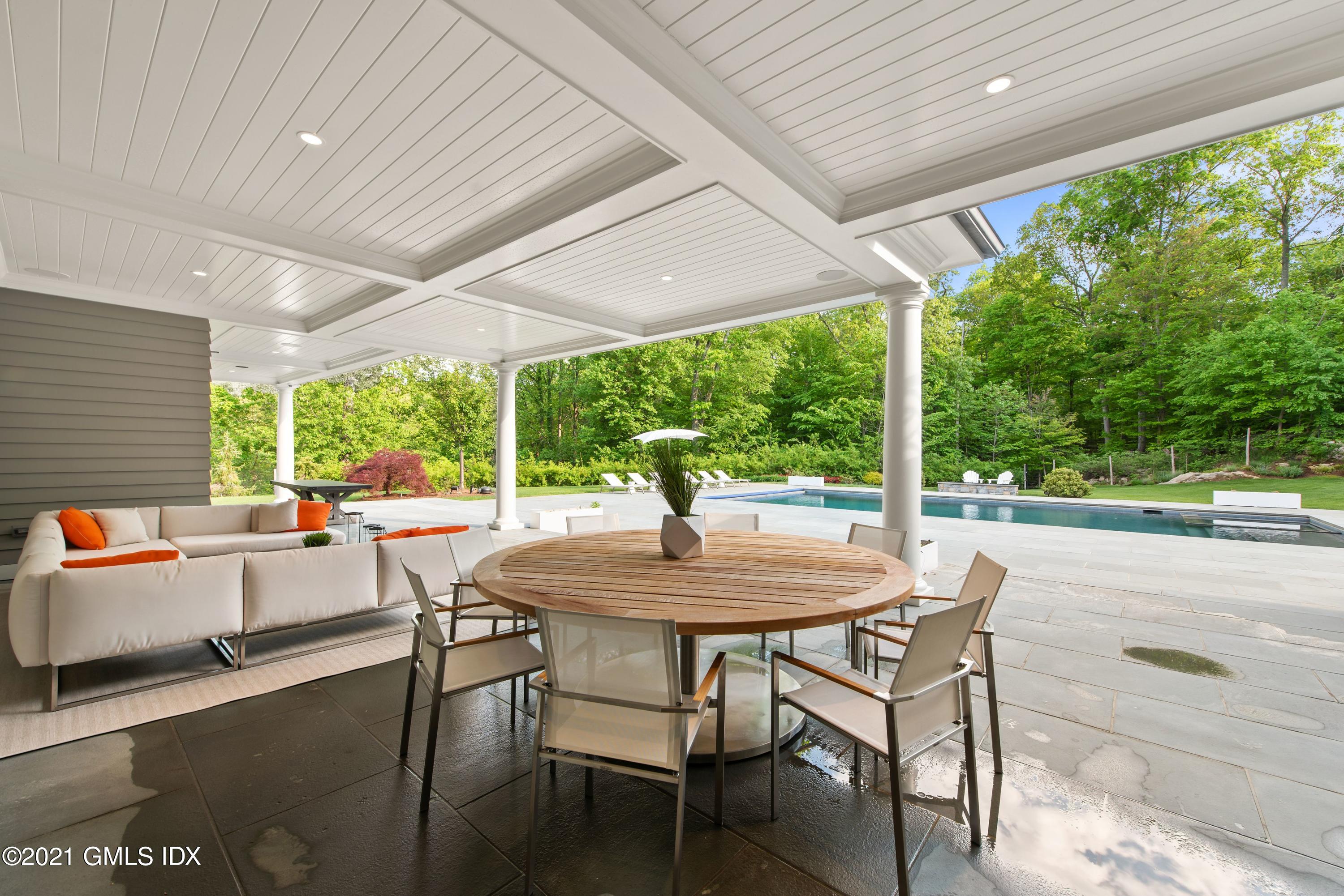 434 Riversville Road Greenwich, CT 06831 - Photo 38 of 47 a dining room with furniture and a garden