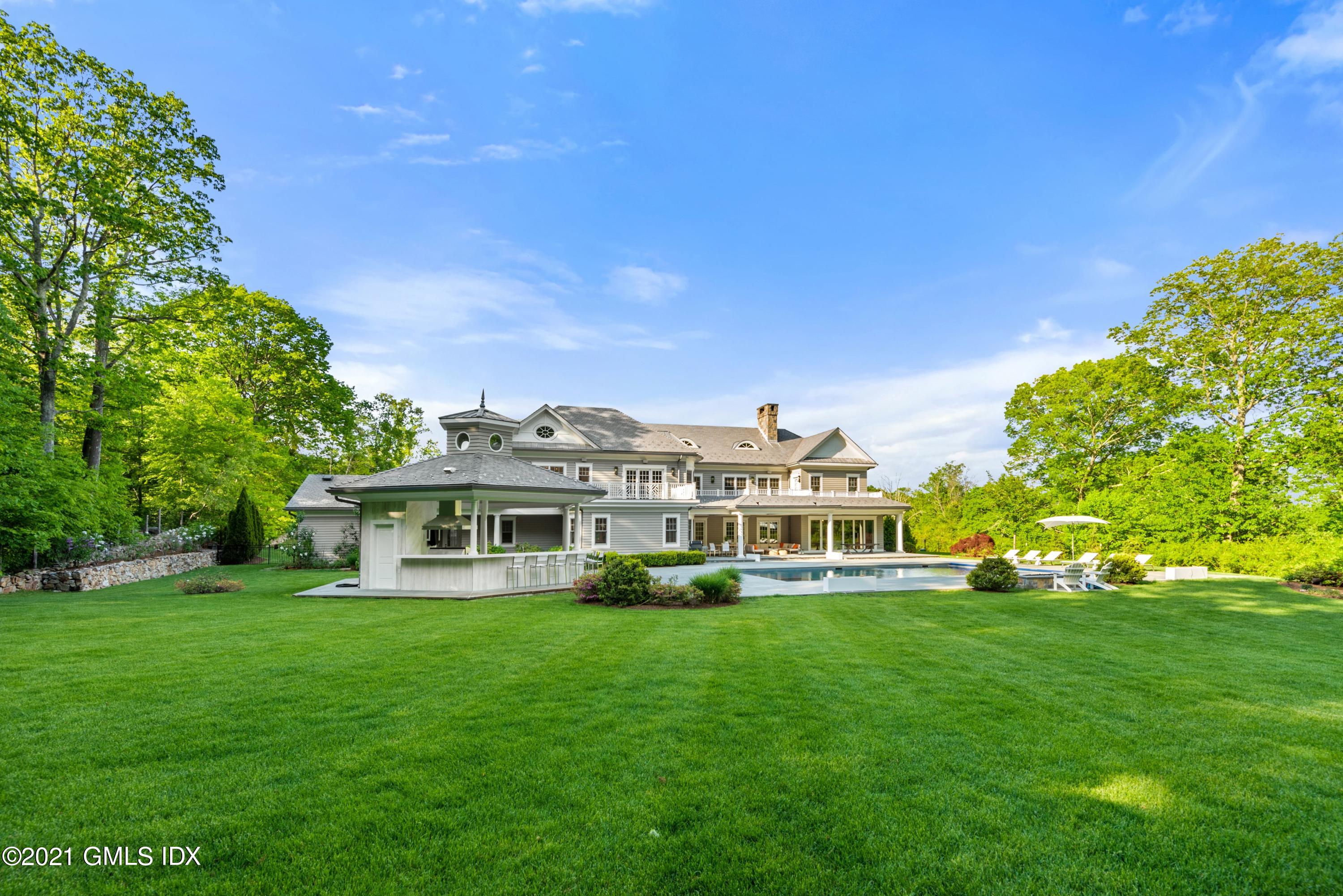 434 Riversville Road Greenwich, CT 06831 - Photo 44 of 47 a front view of a house with a yard table and chairs