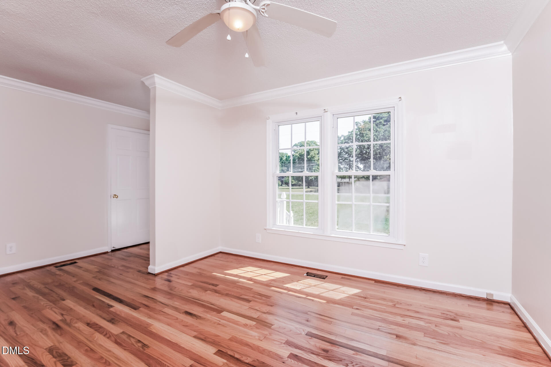 870 Abbott Road Henderson, NC 27537 - Photo 7 of 20 an empty room with wooden floor and windows