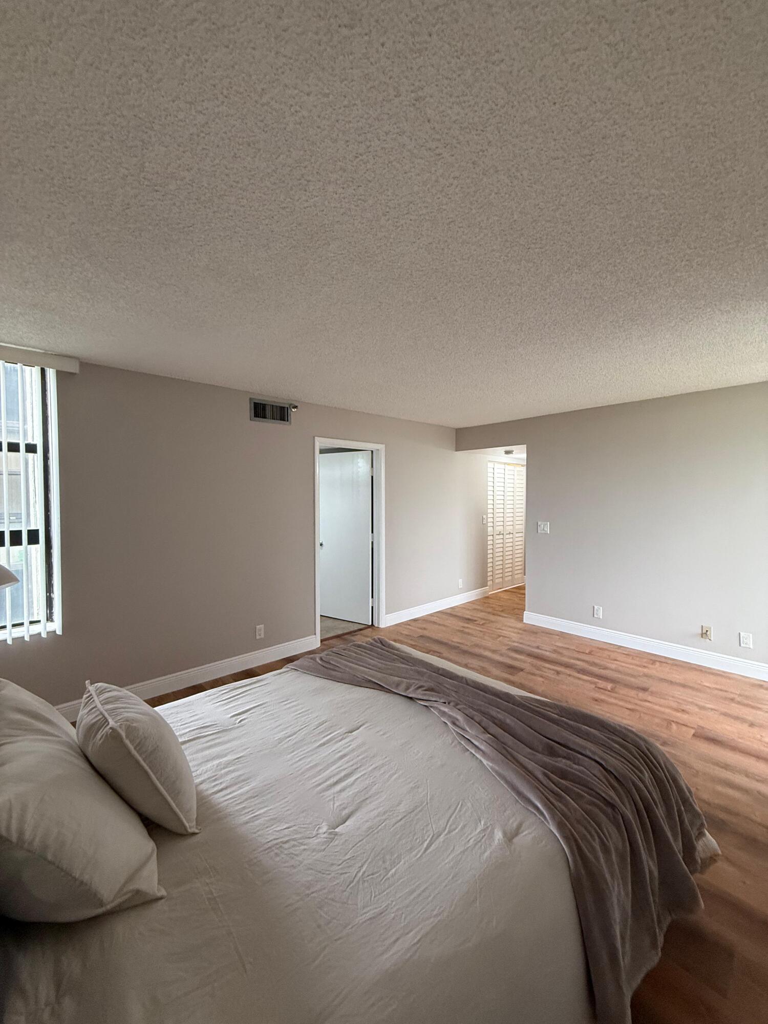 6372 La Costa Drive, Unit 306 Boca Raton, FL 33433 - Photo 12 of 23 a bedroom with a bed and a window