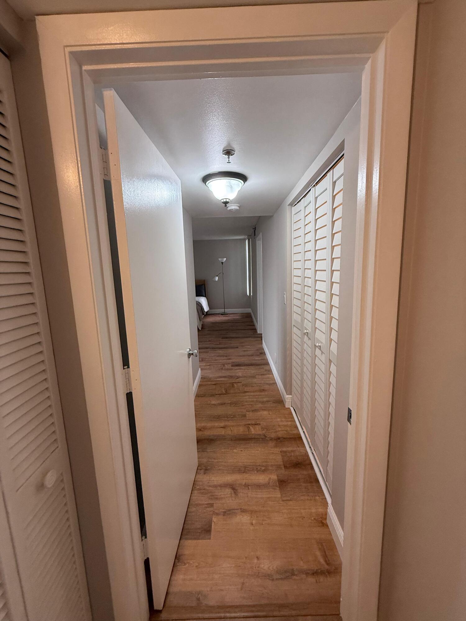 6372 La Costa Drive, Unit 306 Boca Raton, FL 33433 - Photo 13 of 23 a view of a hallway with wooden floor and staircase