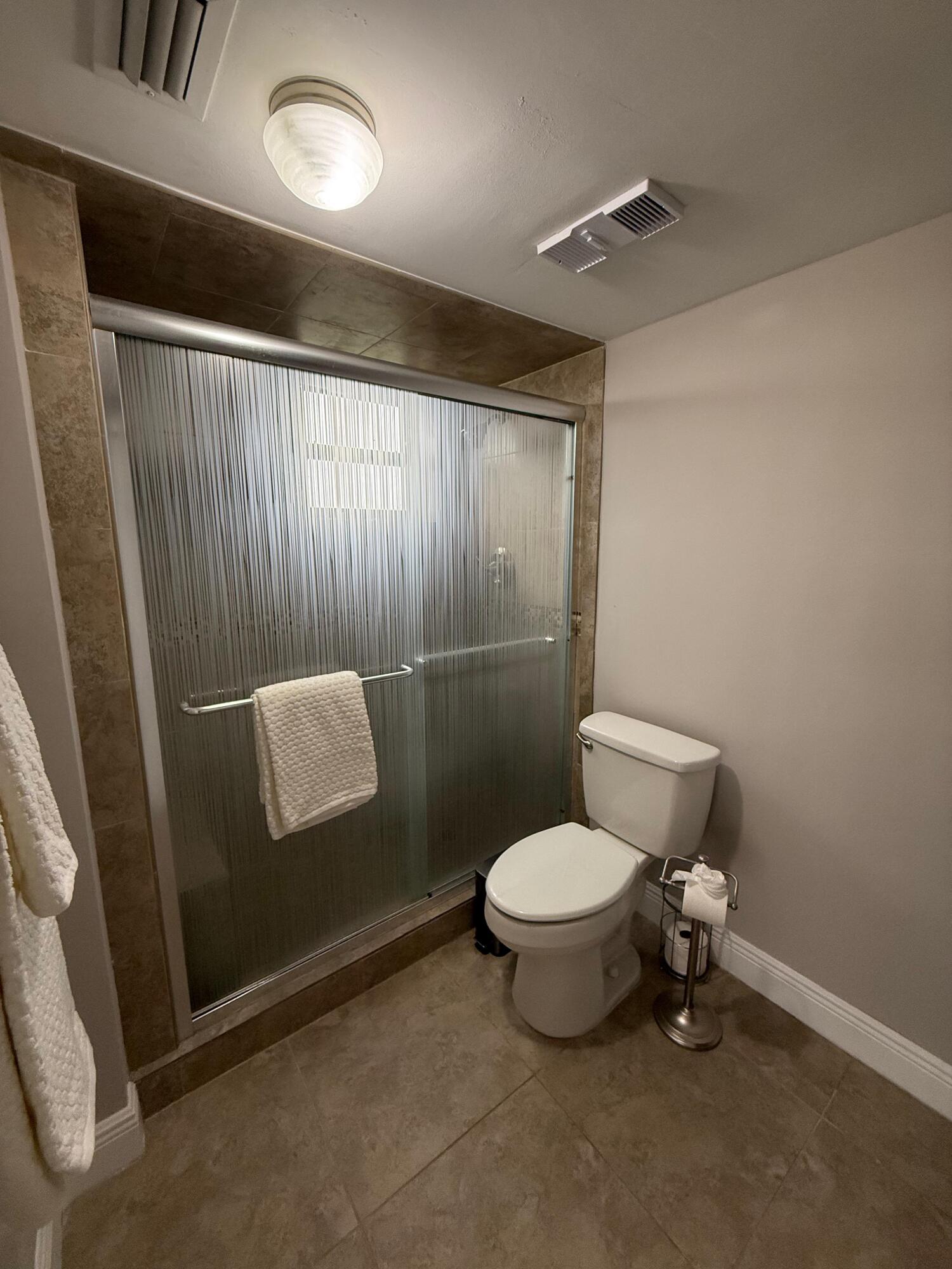 6372 La Costa Drive, Unit 306 Boca Raton, FL 33433 - Photo 18 of 23 a bathroom with a toilet and a shower
