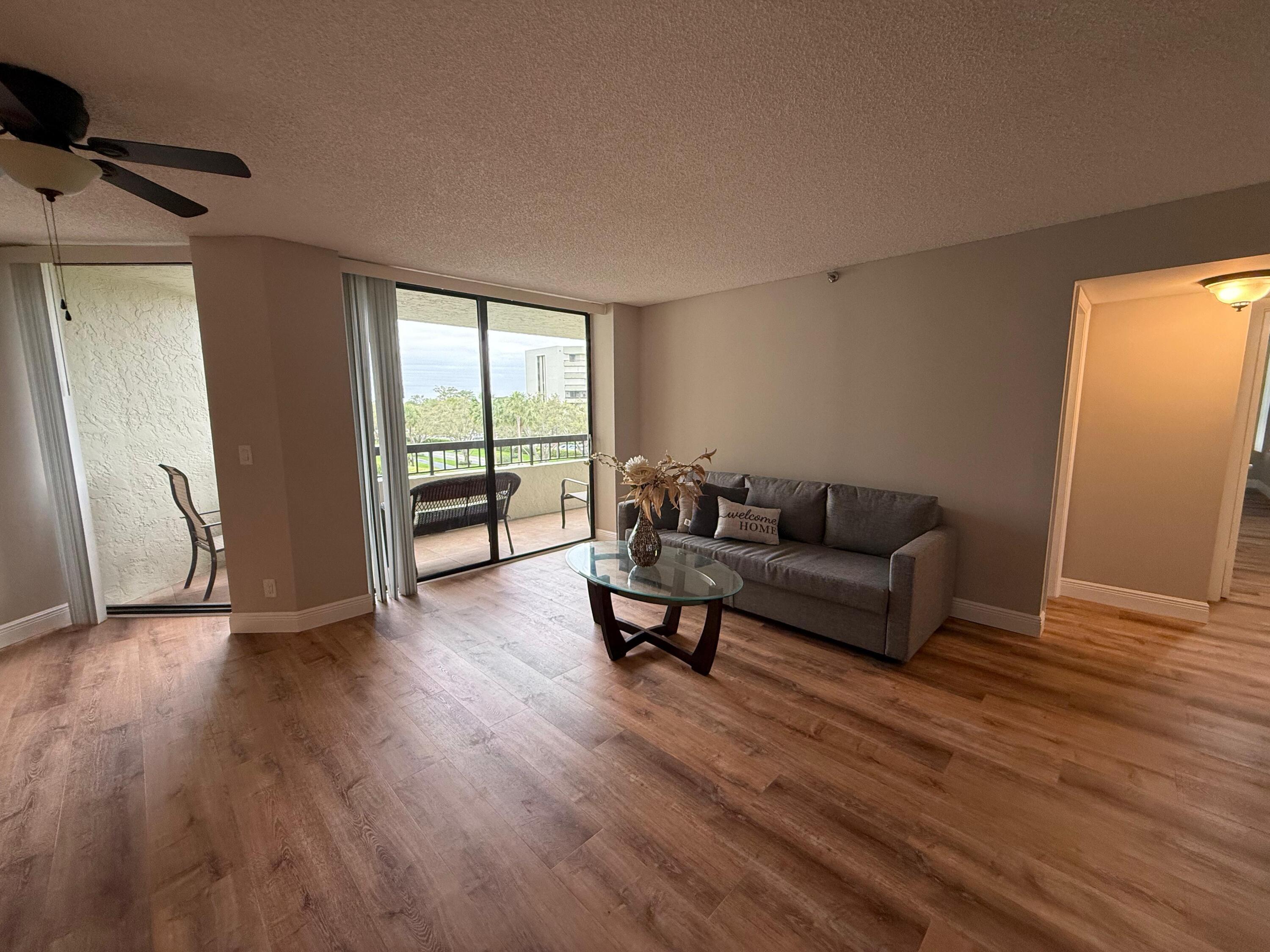 6372 La Costa Drive, Unit 306 Boca Raton, FL 33433 - Photo 3 of 23 a living room with furniture and a wooden floor