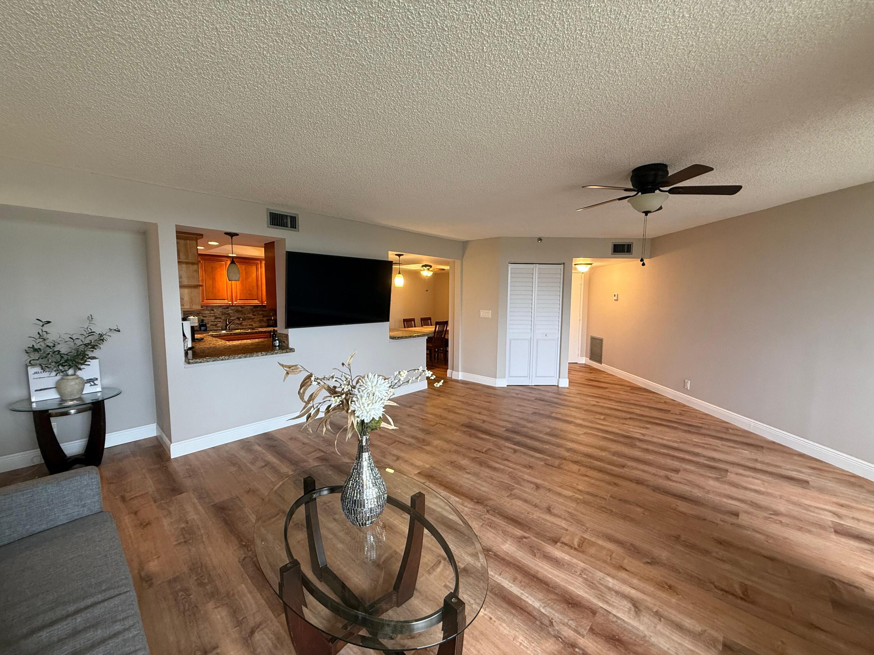 6372 La Costa Drive, Unit 306 Boca Raton, FL 33433 - Photo 4 of 23 a living room with furniture and a flat screen tv