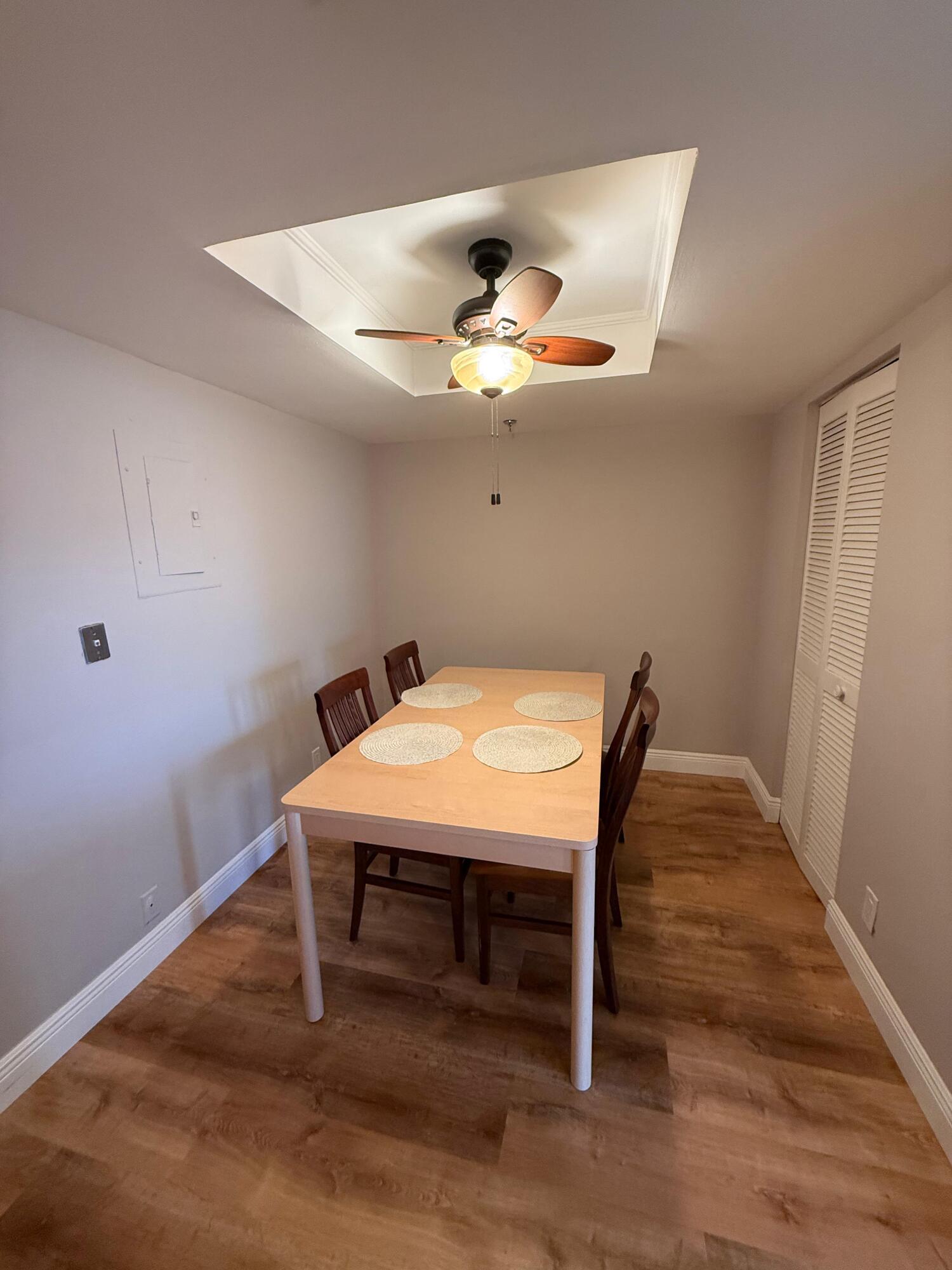 6372 La Costa Drive, Unit 306 Boca Raton, FL 33433 - Photo 9 of 23 a room with a table and chandelier fan