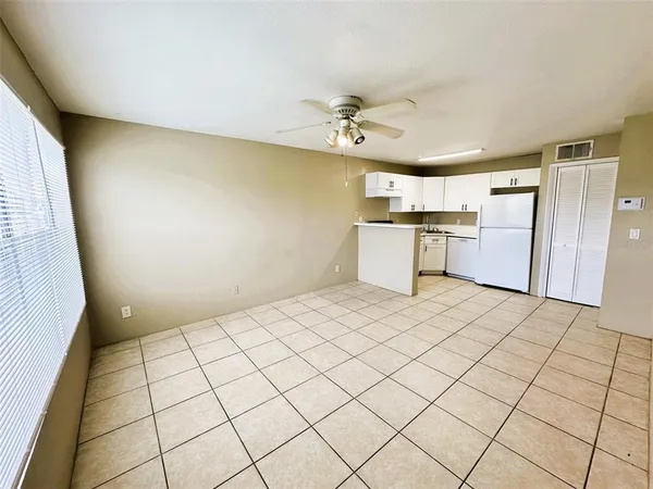 a large white kitchen with a white cabinet and a stove top oven