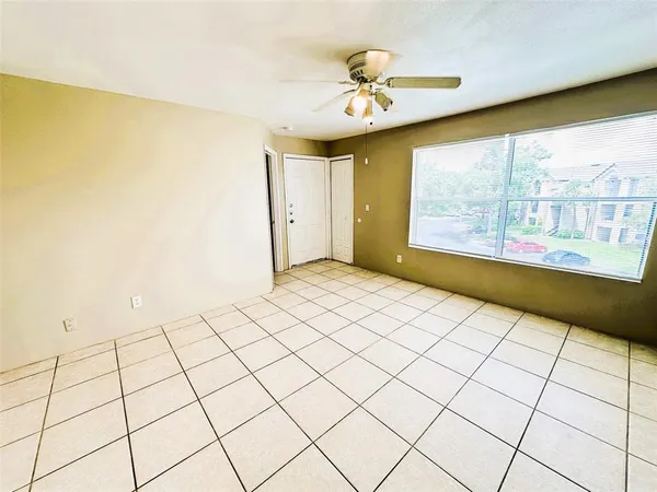 a view of an empty room and a window