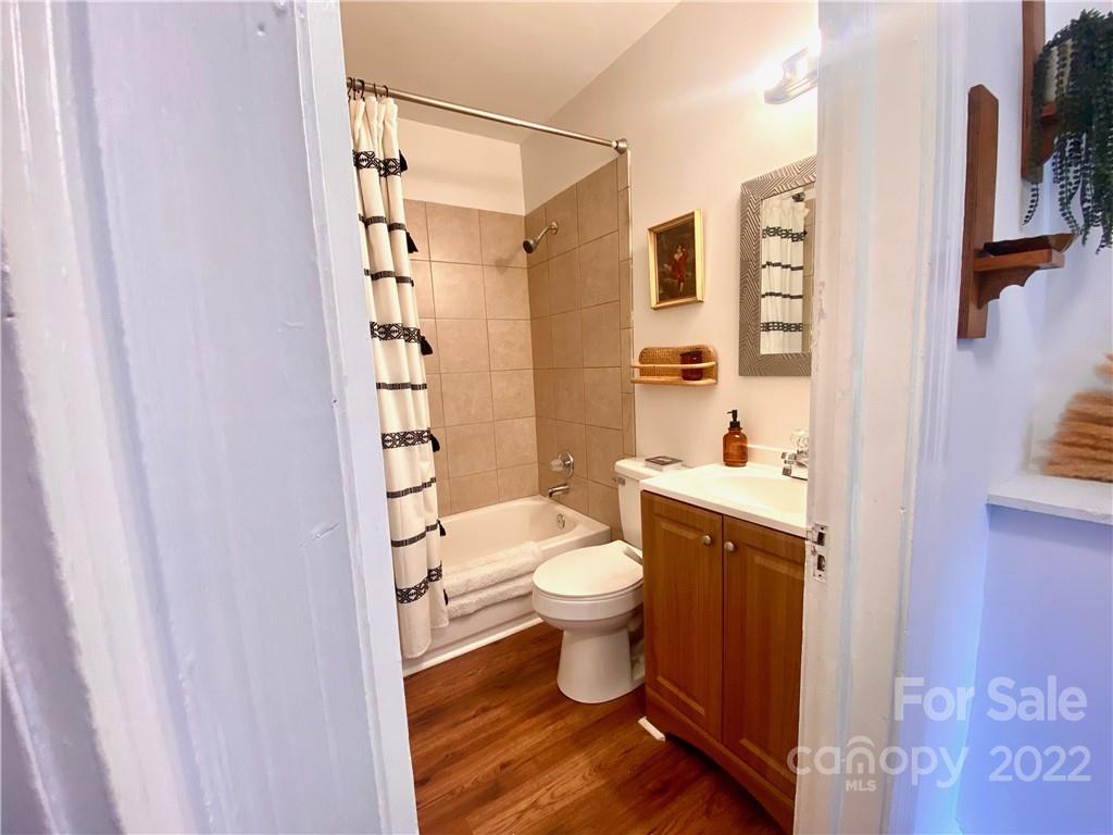 1240 Skyview Road Charlotte, NC 28208 - Photo 13 of 30 a bathroom with a toilet and a shower