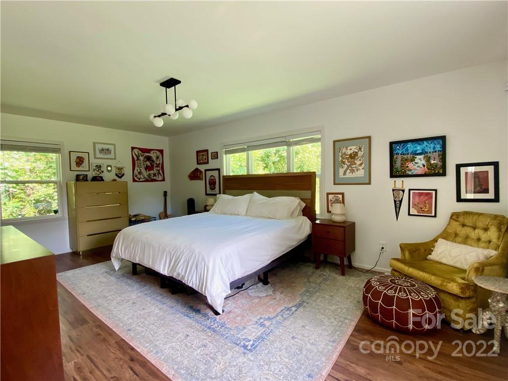 1240 Skyview Road Charlotte, NC 28208 - Photo 14 of 30 a spacious bedroom with a bed a dresser and next to a window
