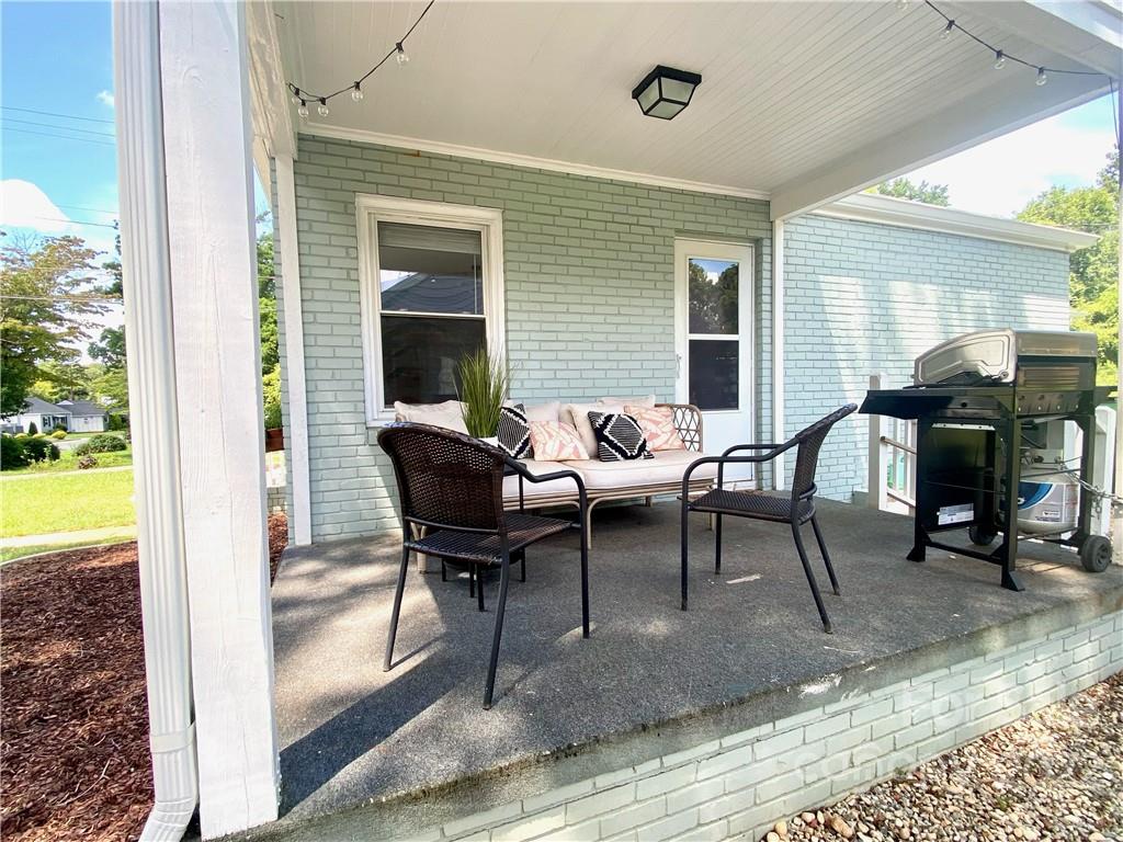 1240 Skyview Road Charlotte, NC 28208 - Photo 24 of 30 a view of a dining room with a table and chairs