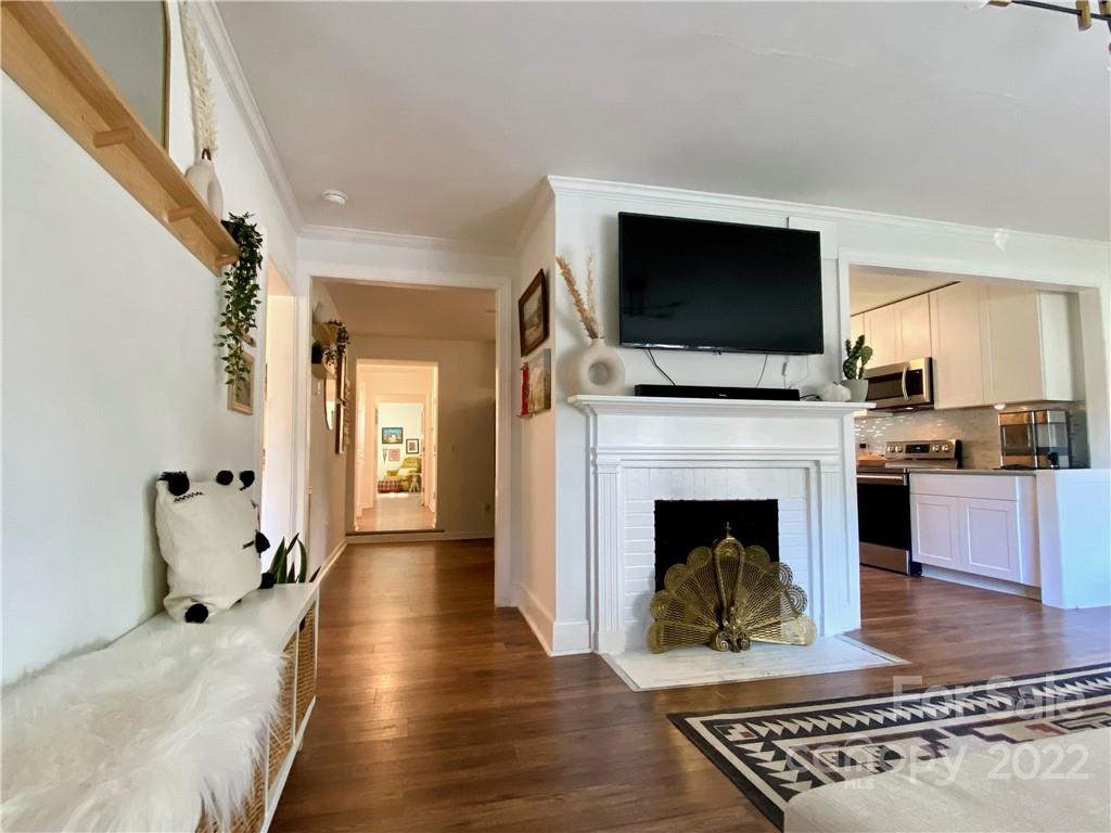 1240 Skyview Road Charlotte, NC 28208 - Photo 4 of 30 a living room with furniture and a fireplace with wooden floor