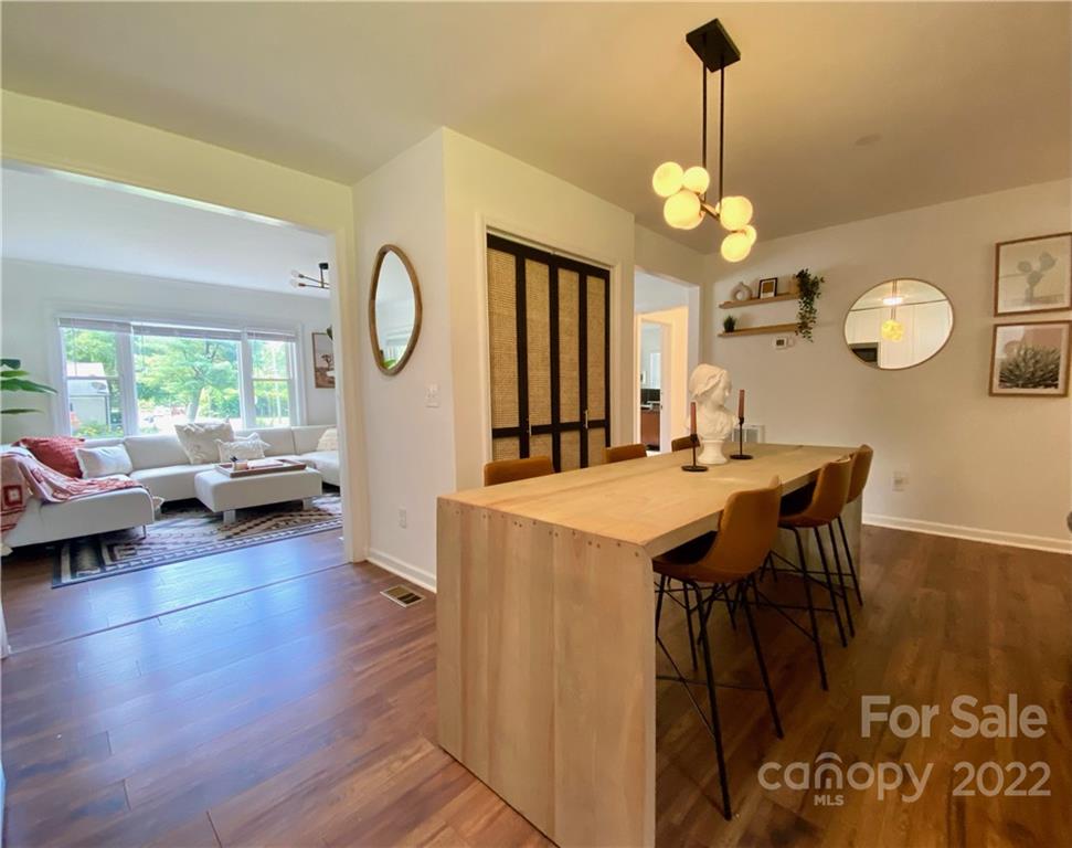 1240 Skyview Road Charlotte, NC 28208 - Photo 5 of 30 a view of a dining room with furniture large window and wooden floor