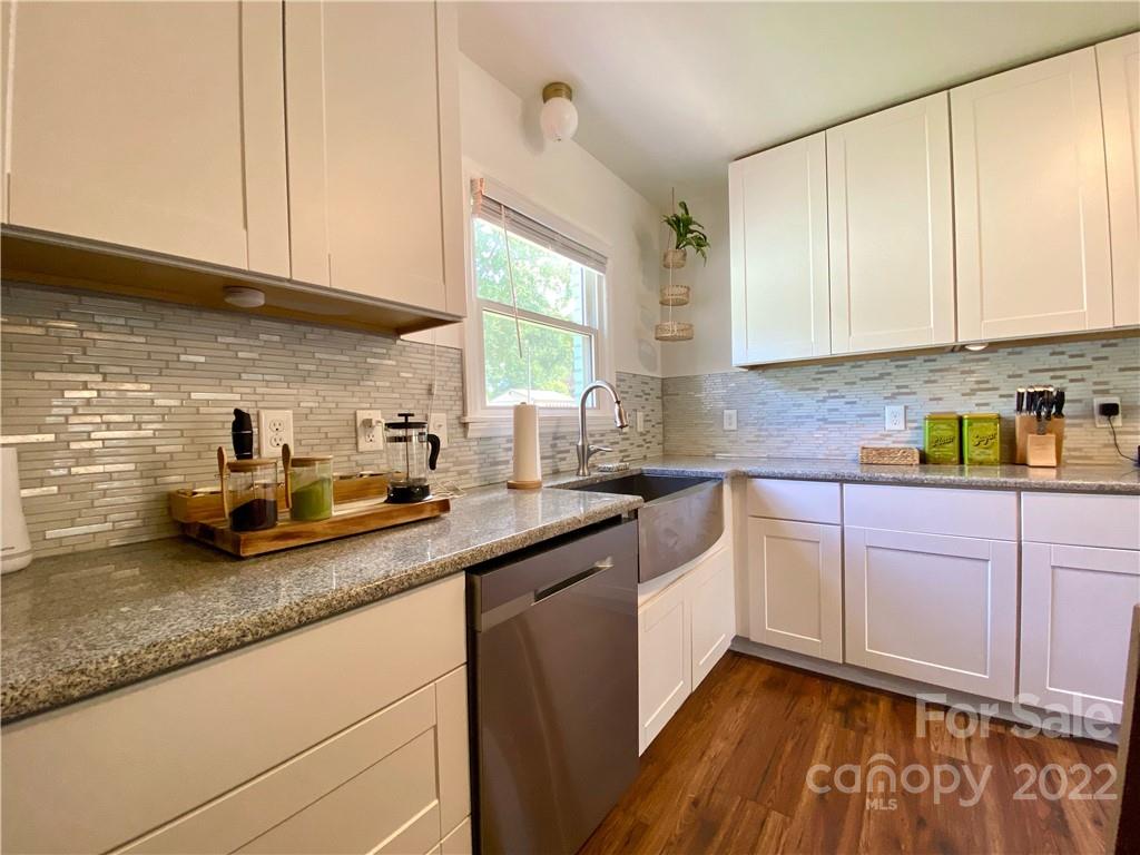 1240 Skyview Road Charlotte, NC 28208 - Photo 9 of 30 a kitchen with stainless steel appliances granite countertop a sink a stove and cabinets