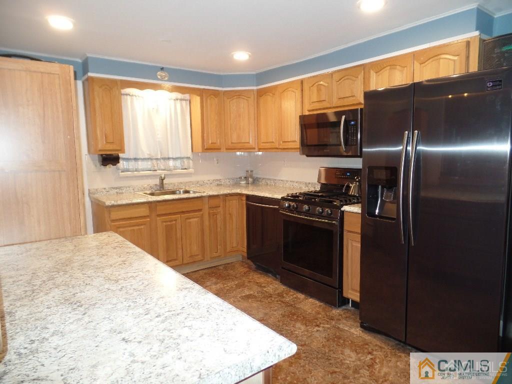 85 Jordan Road Colonia, NJ 07067 - Photo 7 of 17 a kitchen with stainless steel appliances granite countertop a stove a sink and a refrigerator