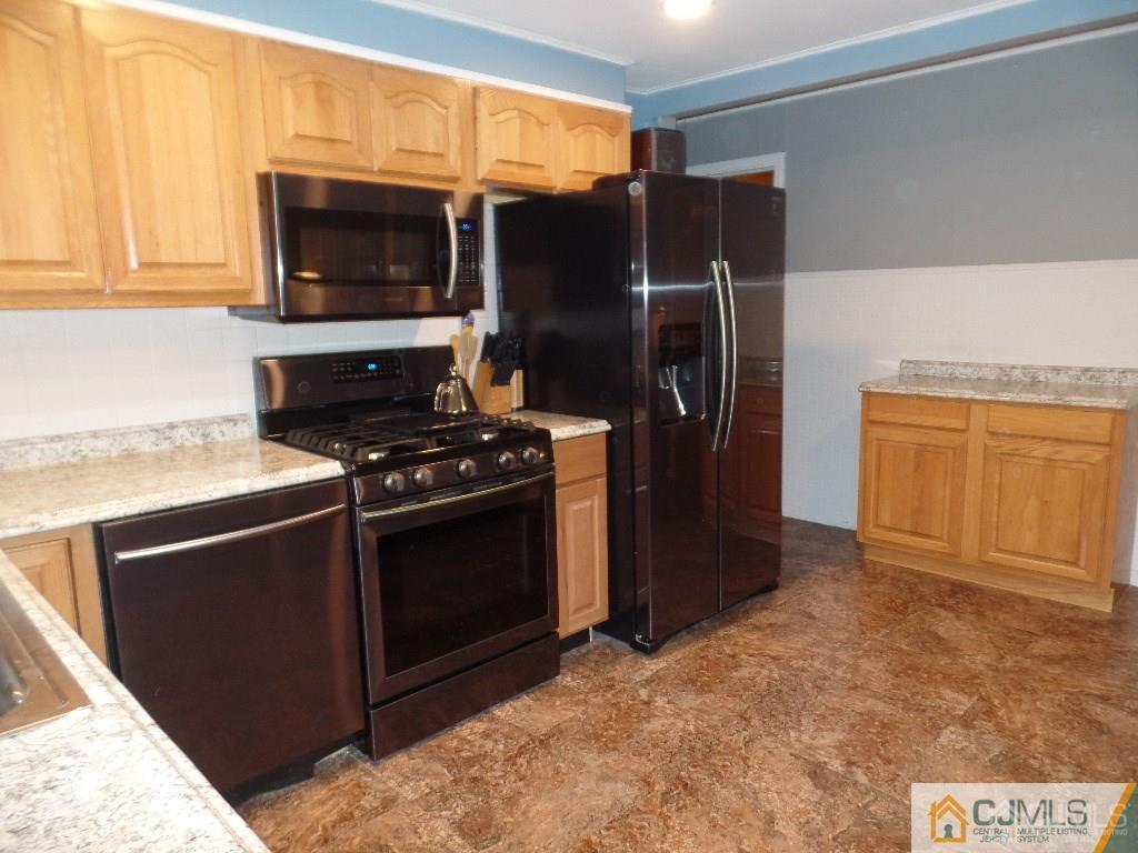 85 Jordan Road Colonia, NJ 07067 - Photo 8 of 17 a kitchen with stainless steel appliances a stove a microwave and a refrigerator