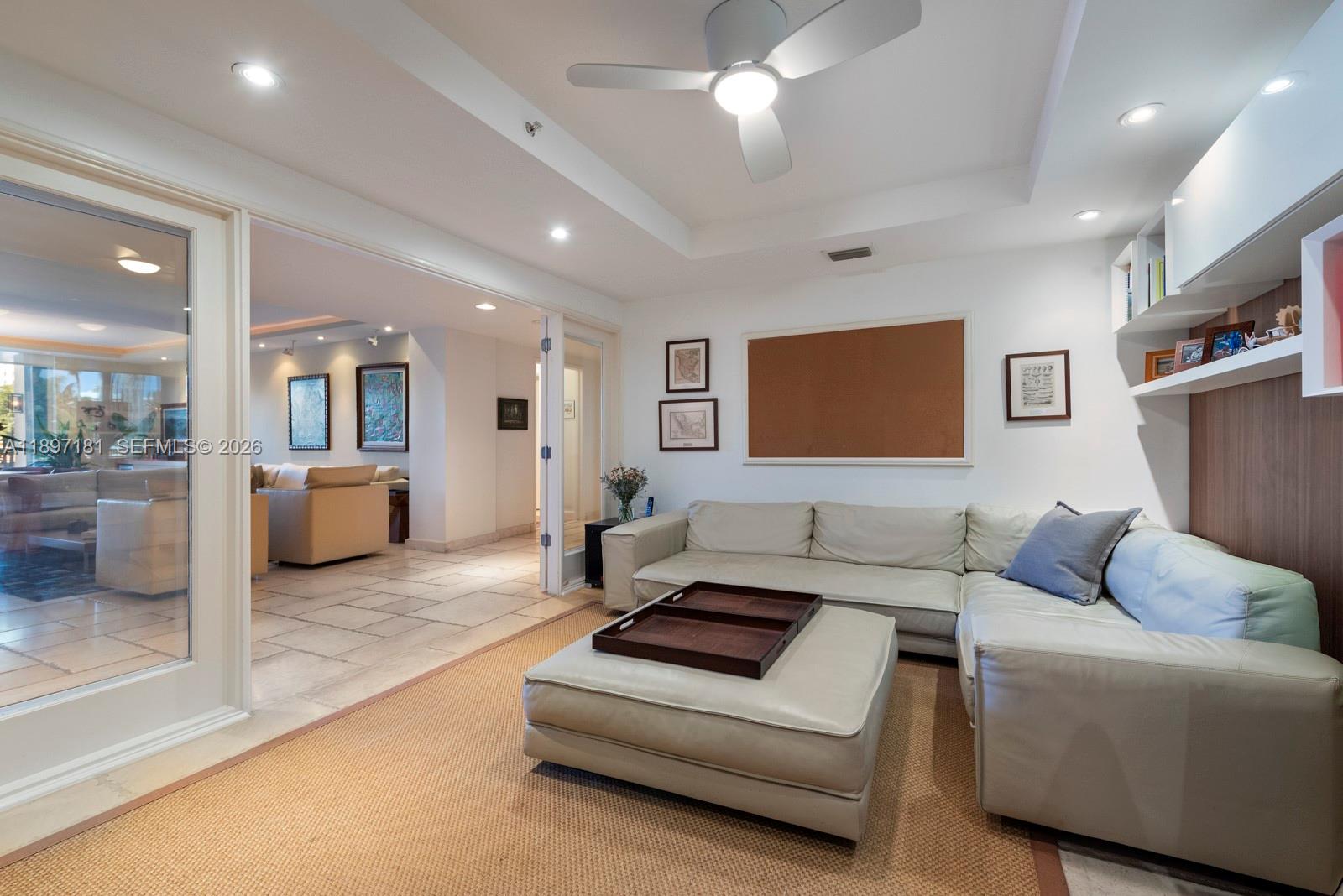 765 Crandon Boulevard, Unit 102 Key Biscayne, FL 33149 - Photo 12 of 37 a living room with furniture and a flat screen tv