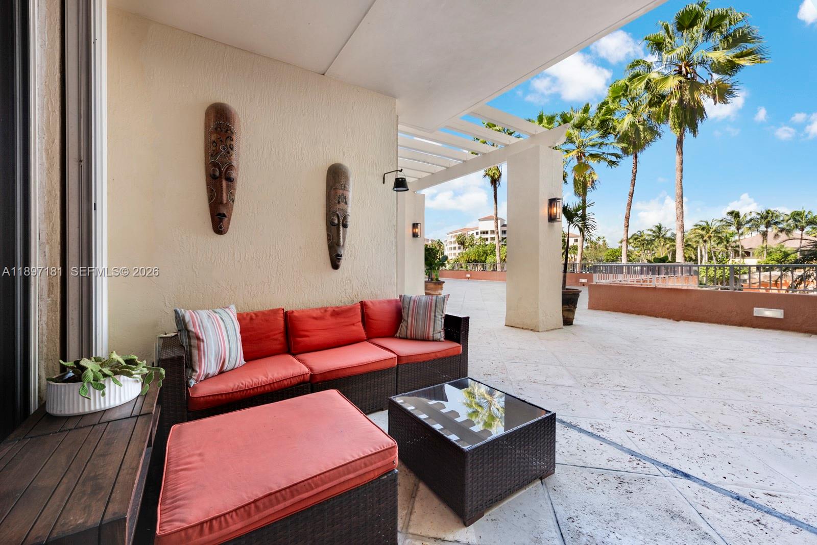 765 Crandon Boulevard, Unit 102 Key Biscayne, FL 33149 - Photo 20 of 37 a living room with furniture and a potted plant