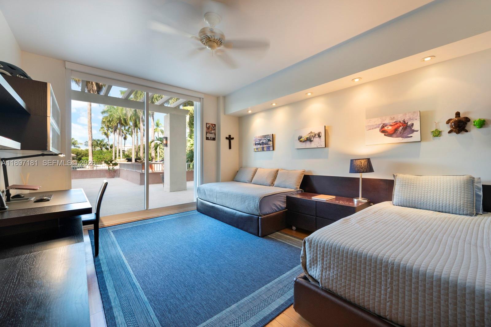 765 Crandon Boulevard, Unit 102 Key Biscayne, FL 33149 - Photo 21 of 37 a bedroom with two beds and a large window