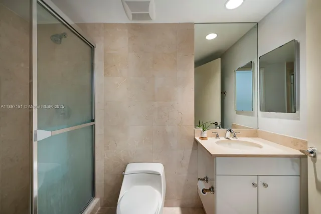 a living room with furniture floor to ceiling window and wooden floor