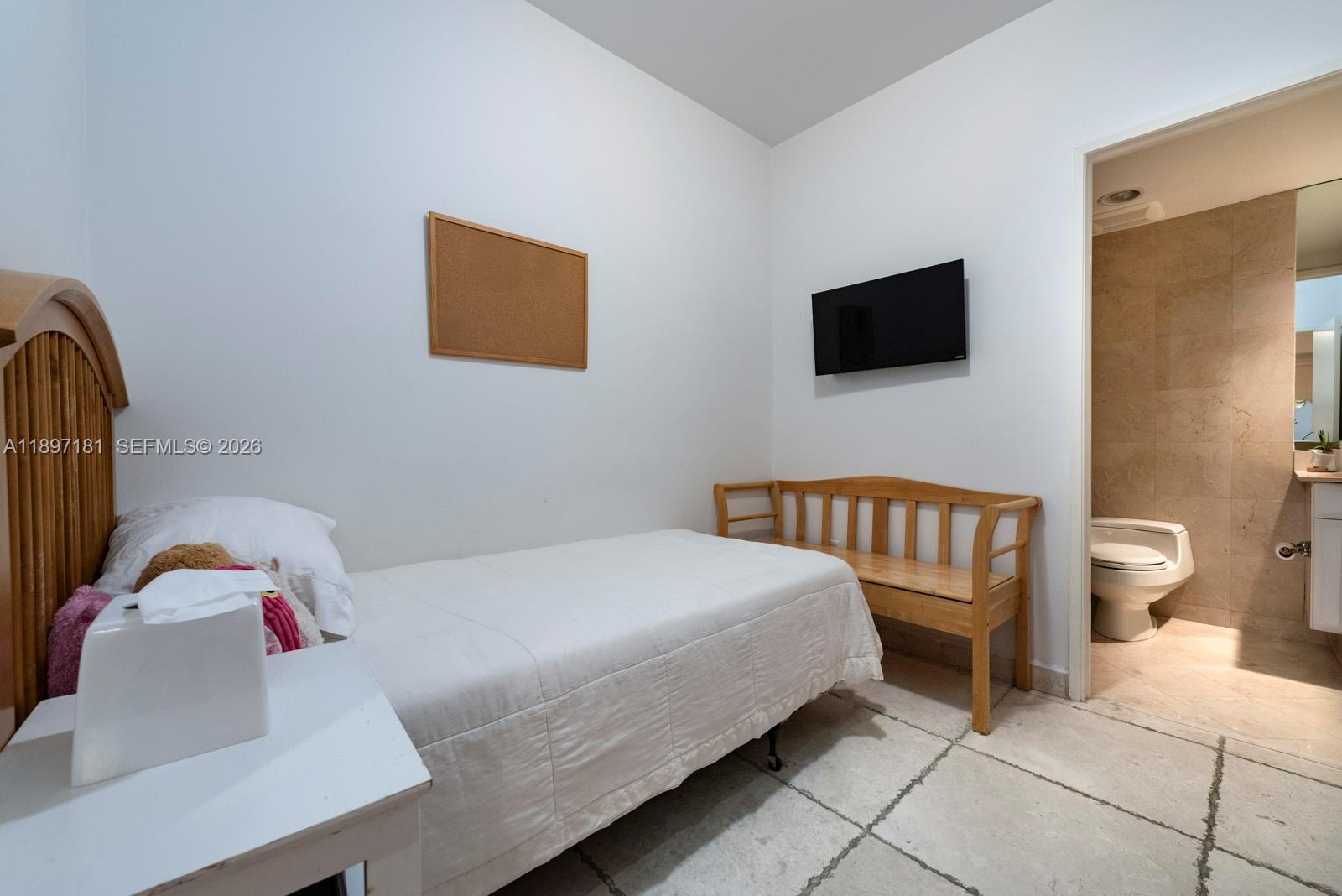 765 Crandon Boulevard, Unit 102 Key Biscayne, FL 33149 - Photo 25 of 37 a bedroom with a bed and a television