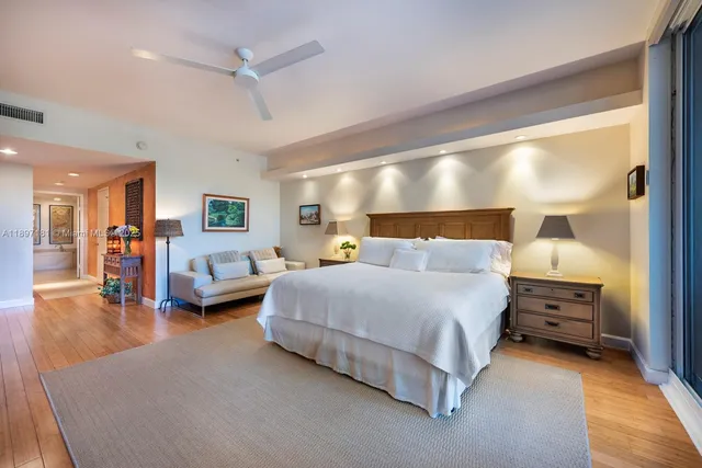 a large bedroom with bed and flat tv