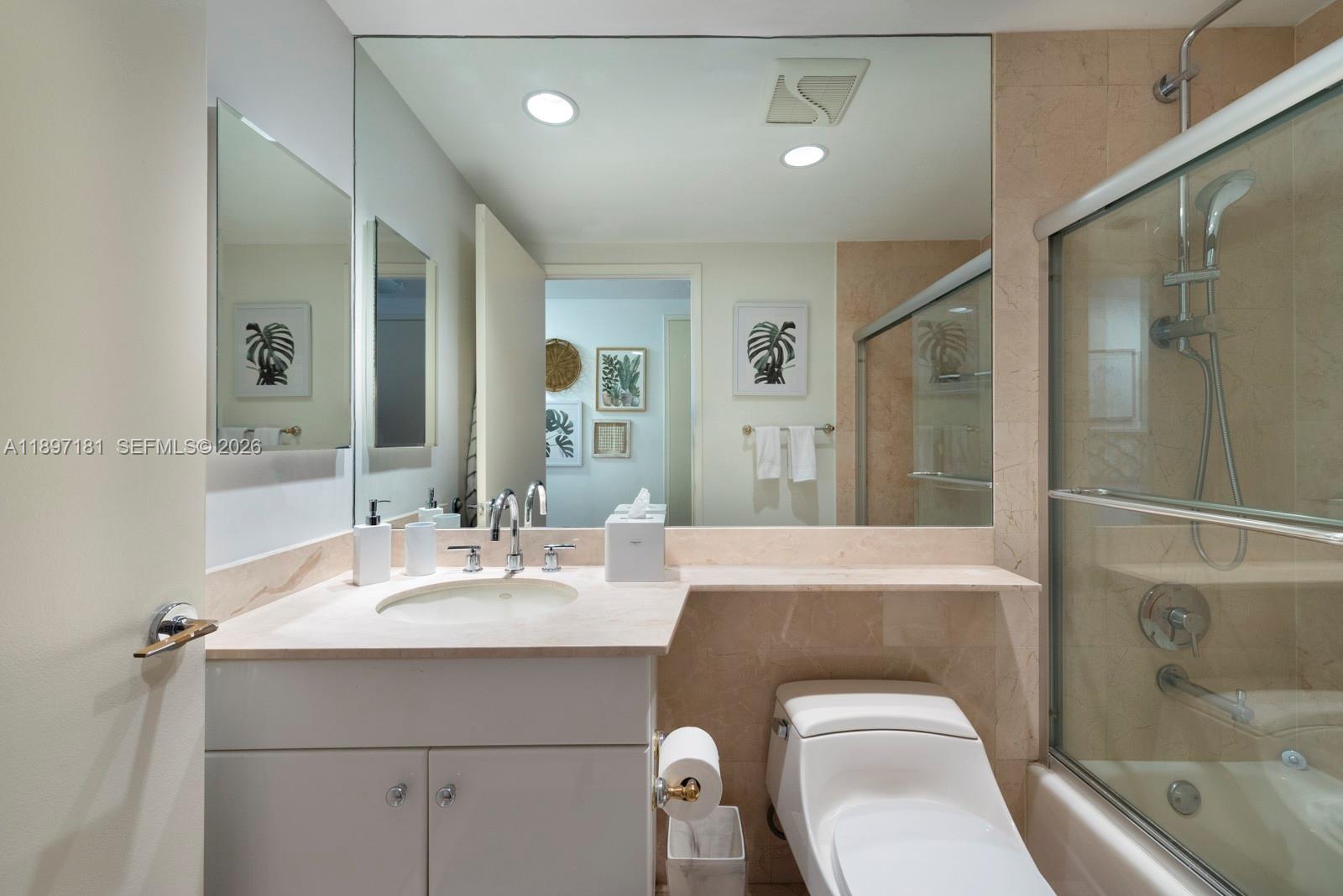 765 Crandon Boulevard, Unit 102 Key Biscayne, FL 33149 - Photo 27 of 37 a bathroom with a toilet a sink and bathtub