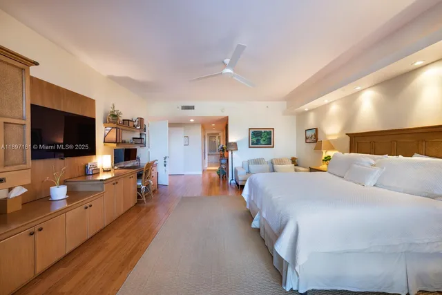a large white bathroom with a large tub shower and sink