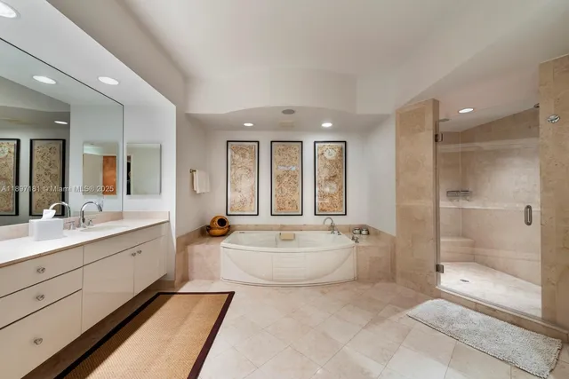 a bathroom with a tub a rug and a glass door