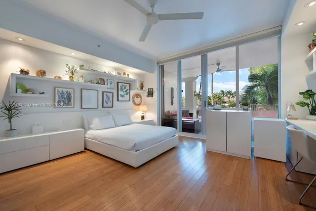 a spacious bedroom with a bed and dresser