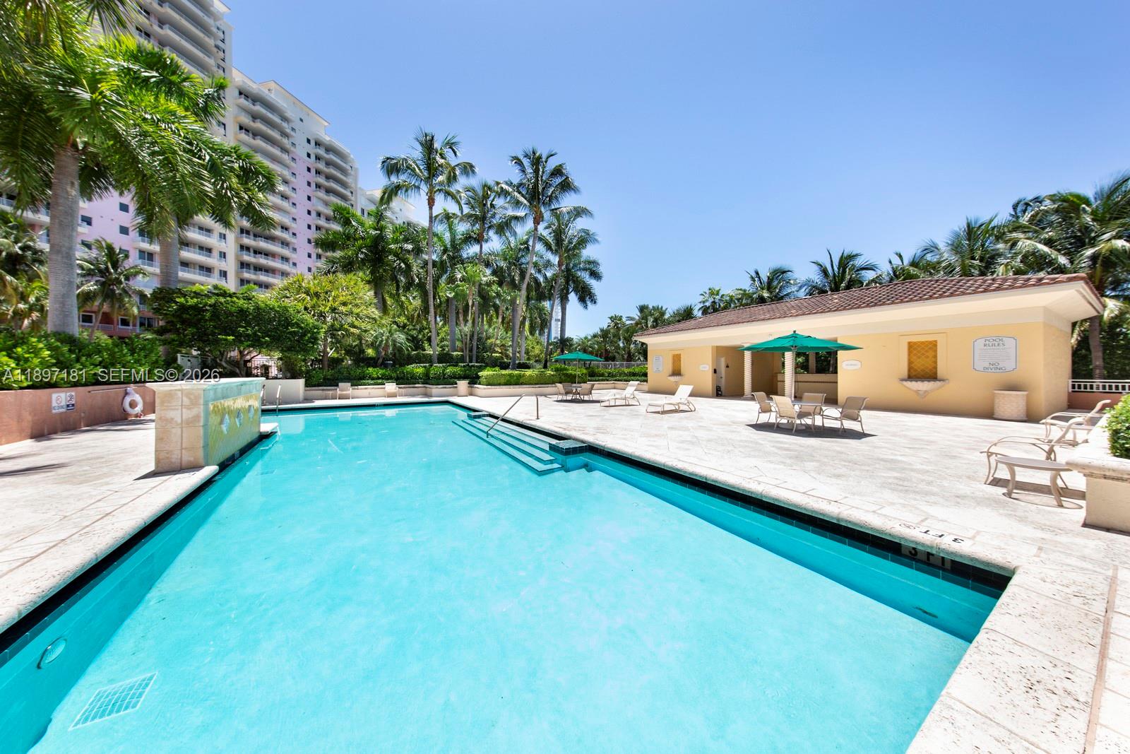 765 Crandon Boulevard, Unit 102 Key Biscayne, FL 33149 - Photo 33 of 37 a swimming pool with patio outdoor seating and yard