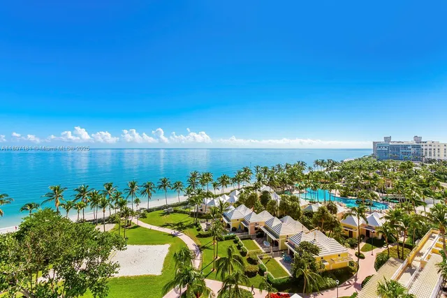 an aerial view of residential houses with outdoor space and trees all around