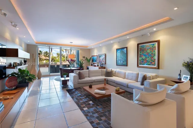 a living room with fireplace furniture and a potted plant