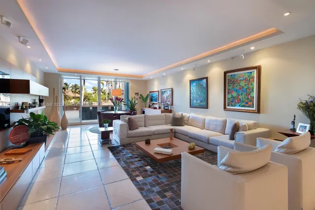 a living room with furniture a flat screen tv and a large window